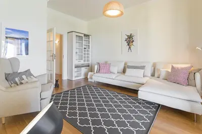 a living room with two white couches and a rug at Vila Eucalipto by An Island Apart in Funchal