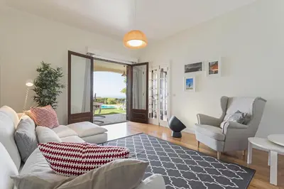 a living room with a couch and two chairs at Vila Eucalipto by An Island Apart in Funchal