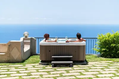 two men sitting at a table with glasses of wine at Vila Eucalipto by An Island Apart in Funchal