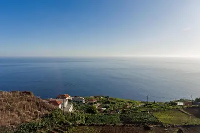 a view of the ocean from a hill at Searenity Vacation Home I by An Island Apart in Arco da Calheta