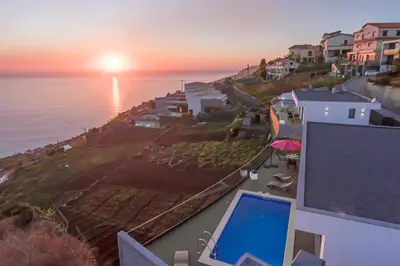 a view of the ocean from a house with a laptop at Searenity Vacation Home II by An Island Apart in Arco da Calheta