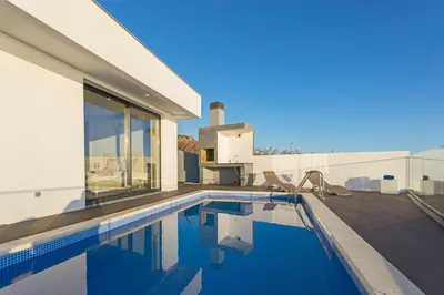 a swimming pool in the backyard of a house at Searenity Vacation Home II by An Island Apart in Arco da Calheta