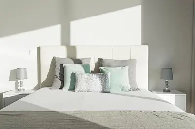 a white bedroom with a large bed with pillows at Searenity Vacation Home II by An Island Apart in Arco da Calheta