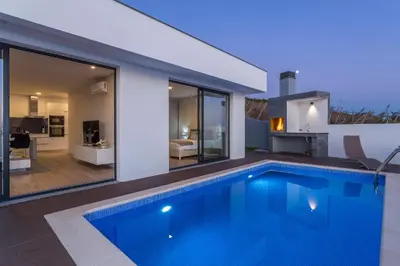 a swimming pool in the backyard of a house at Searenity Vacation Home II by An Island Apart in Arco da Calheta