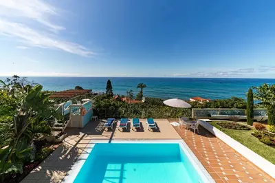 a view of the ocean from a house with a swimming pool at OurMadeira - Villa do Mar III in Arco da Calheta