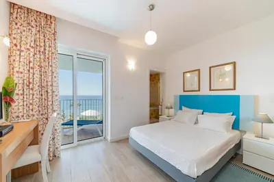 a bedroom with a bed and a large window at OurMadeira - Villa do Mar III in Arco da Calheta