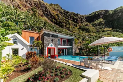 a house with a pool and a mountain at OurMadeira - Villa do Mar III in Arco da Calheta