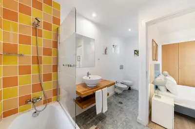 a bathroom with a tub and a sink and a toilet at OurMadeira - Villa do Mar III in Arco da Calheta