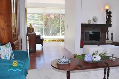 a living room with a coffee table and a fireplace at OurMadeira - Casa do Júlio in Calheta