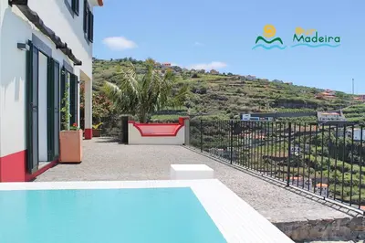 a villa with a swimming pool and a fence at OurMadeira - Casa do Júlio in Calheta