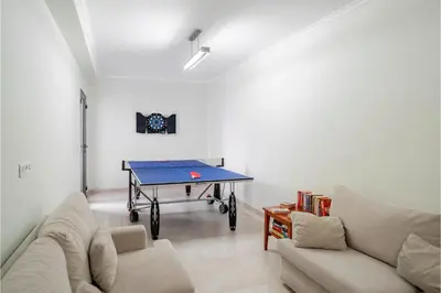a living room with a ping pong table in it at OurMadeira - Casa Amaro Mar in Arco da Calheta