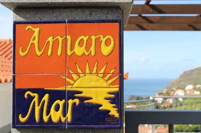 a sign for a marmitemite man on a wall at OurMadeira - Casa Amaro Mar in Arco da Calheta