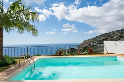 a swimming pool with a view of the ocean at OurMadeira - Casa Amaro Mar in Arco da Calheta