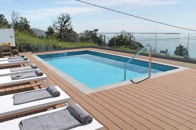 a swimming pool on top of a wooden deck at OurMadeira - Vila da Portada in Funchal