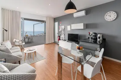 a dining room and living room with a glass table at OurMadeira - Vila da Portada in Funchal
