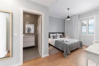 a white bedroom with a bed and a sink at OurMadeira - Vila da Portada in Funchal
