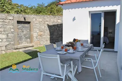 a table and chairs on the patio of a house at OurMadeira - Calheta Heights in Calheta