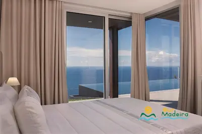 a bedroom with a view of the ocean at OurMadeira - Cliffscape in Estreito da Calheta