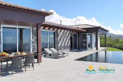 a villa with a swimming pool and a patio at OurMadeira - Cliffscape in Estreito da Calheta