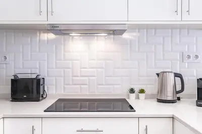 a kitchen counter with a sink and a microwave at Cayres Suites Surdo in Funchal