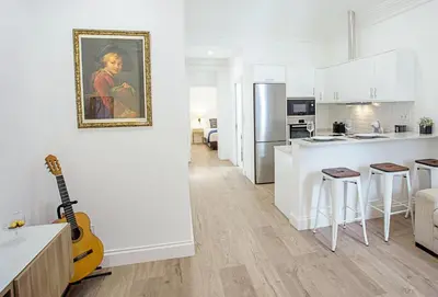 a kitchen with a guitar in a white kitchen at Cayres Suites Surdo in Funchal