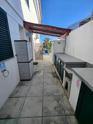 a patio with a counter and a refrigerator in a building at PORTO SANTO MyLove in Porto Santo