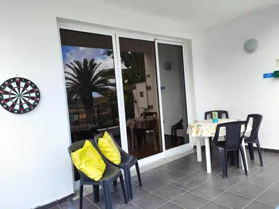 a dining room with a table with yellow pillows at PORTO SANTO MyLove in Porto Santo
