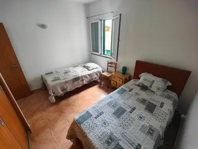 a bedroom with two beds and a window at PORTO SANTO MyLove in Porto Santo