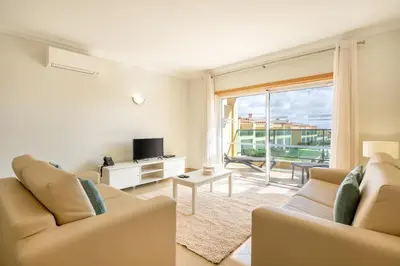 a living room with two couches and a television at Boavista Golf & Spa - Bela Colina Holidays in Lagos