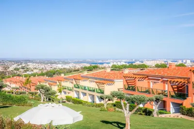 a white tent on a lawn in front of a building at Boavista Golf & Spa - Bela Colina Holidays in Lagos