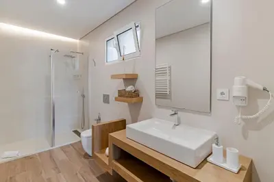 a white bathroom with a sink and a shower at NEW! Villa Alvinho| Lifestyle&Nature | Heated Pool in Funchal