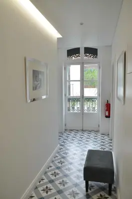 a hallway with a chair and a window at Edificio Charles 204 in Funchal