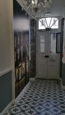 a hallway with a white door and a tile floor at Edificio Charles 204 in Funchal