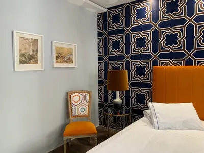 a bedroom with a bed and a chair at Central - São Pedro Boutique in Funchal