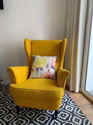 a yellow chair with a pillow in a room at Central - São Pedro Boutique in Funchal