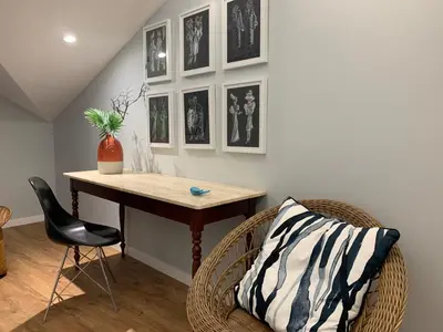 a room with a table and a chair and pictures on the wall at Central - São Pedro Boutique in Funchal
