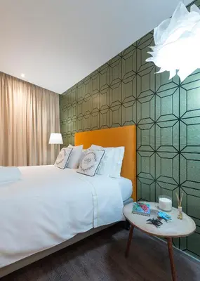 a bedroom with a large bed and a table at Central - São Pedro Boutique in Funchal