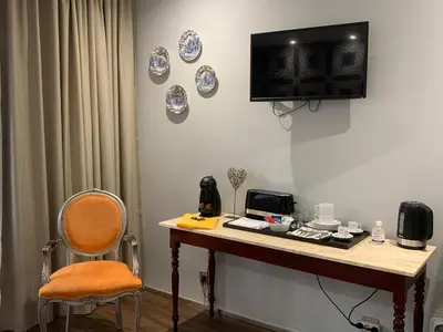 a table with a chair and plates on the wall at Central - São Pedro Boutique in Funchal