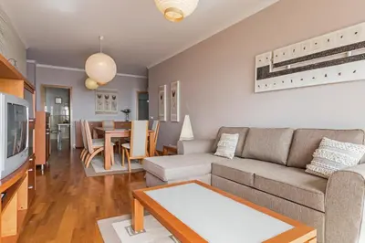 a living room with a couch and a table at Reis Magos II by An Island Apart in Caniço