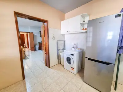 a kitchen with a washing machine and a refrigerator at Casa da Achada in Arco da Calheta in Arco da Calheta