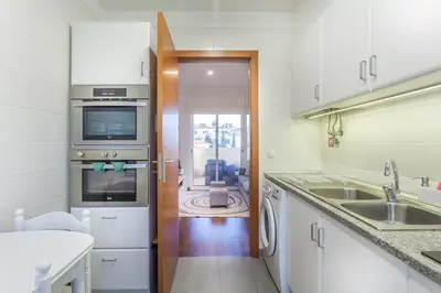 a kitchen with a sink and a stove top oven at Blue Sky in Funchal