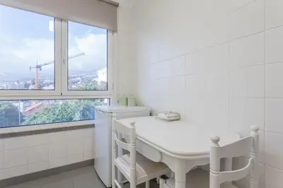 a white bathroom with a sink and a window at Blue Sky in Funchal