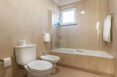 a bathroom with a toilet and a bath tub at Blue Sky in Funchal