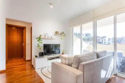 a living room with a couch and a television at Blue Sky in Funchal