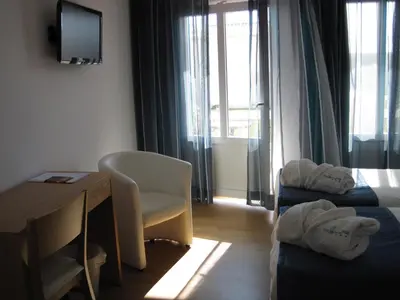 a hotel room with a desk and a chair at Hotel Mira Sagres in Vila do Bispo