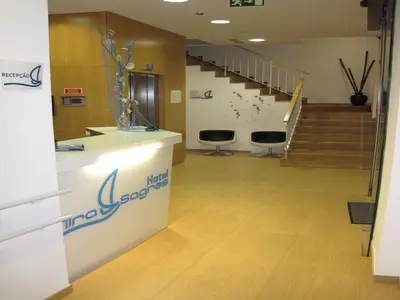 a lobby with stairs and stools in a building at Hotel Mira Sagres in Vila do Bispo
