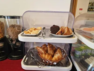 a refrigerator with two trays of pastries and desserts at Hotel Mira Sagres in Vila do Bispo