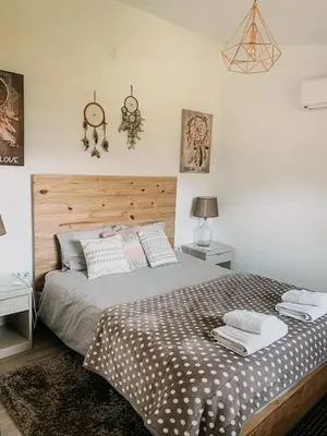 a bedroom with a large bed with a wooden headboard at Granny's farm in São Vicente