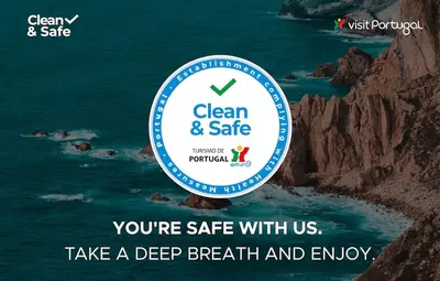 a sign that says clean and safe next to the ocean at Casa Silva in Calheta