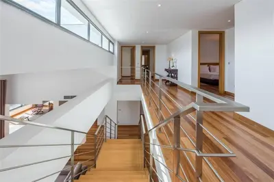 a staircase in a house with white walls and wood floors at Casas do Forte do Pico in Funchal